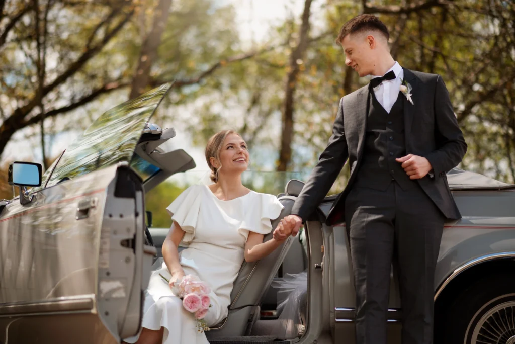 A chauffeur helps a bride into a luxury black car, ideal for premium car service in Portland, Oregon.